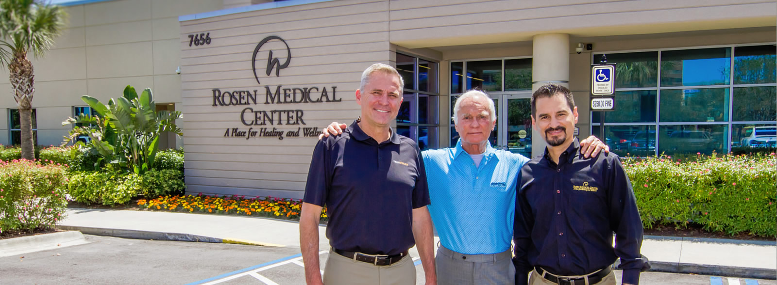 Harris Rosen,Ashley Bacot, and Kenneth A. Aldridge in front of the Medical Center building